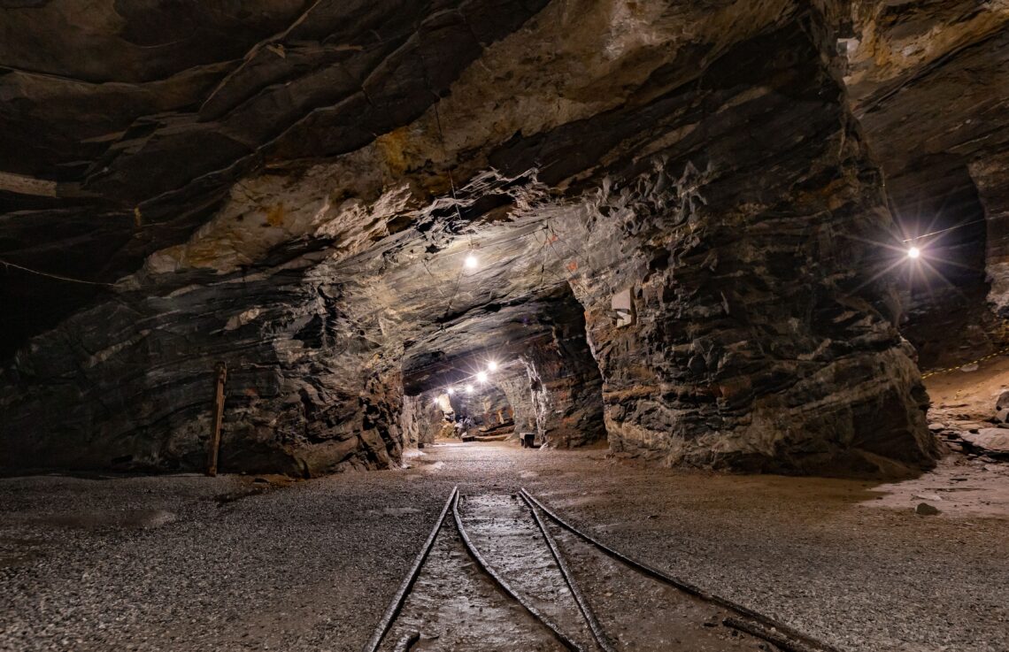 Underground hard-rock mine drift with rail tracks