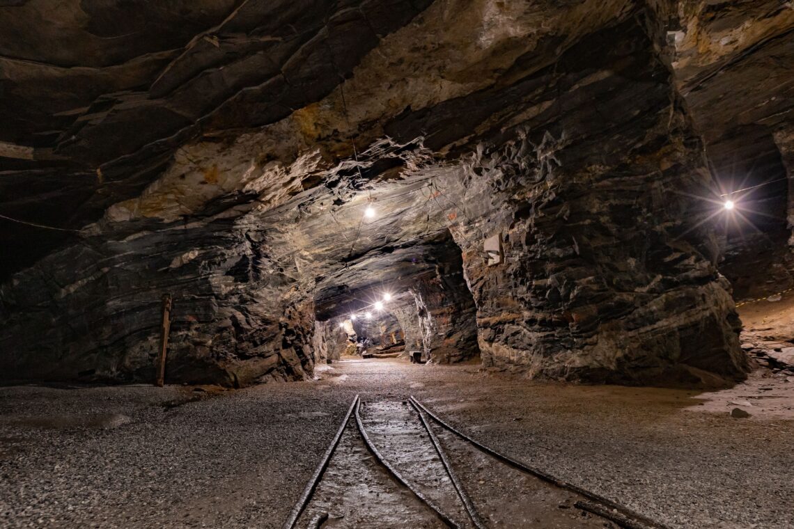 Underground hard-rock mine drift with rail tracks